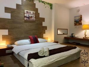 a bedroom with a large bed with two pairs of shoes at The Grace Hotel in Muar