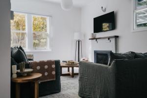 a living room with two couches and a fireplace at Sylvandale in Hepburn Springs