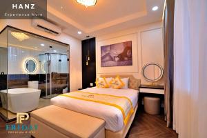a hotel room with a bed and a bath tub at HANZ Premium Friday Hotel in Ho Chi Minh City