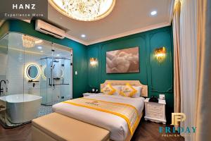 a bedroom with a large bed and a bath tub at HANZ Premium Friday Hotel in Ho Chi Minh City