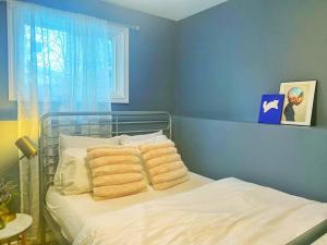 a blue bedroom with a bed with towels on it at Premier Affordable Barrie Suite in Barrie