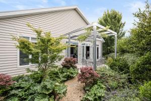 a house with a pergola in the front yard at The Banks in Beechworth +14 photos