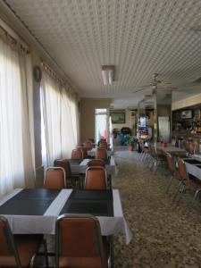 a dining room with tables and chairs and a ceiling at Hotel Alain in Silla