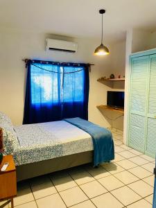um quarto com uma cama com uma cortina azul em Casa Kante em San José del Cabo
