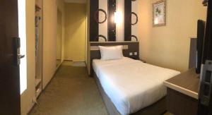 a small bedroom with a bed in a room at The Ardens Hotel - Nong Chik, Kolam Air, Johor Bahru in Johor Bahru