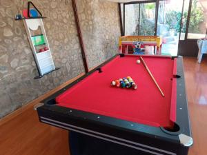 a red pool table in a living room at Oasis del Placer MOYDA in La Paz