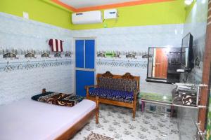 a room with two beds and a chair and a mirror at HOLIDAY INN in Konārka