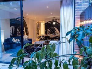 a room with a potted plant in the foreground at The Arches Luxurious Three Bedroom Houses Close to Hampstead Heath with garden balcony and courtyard in London