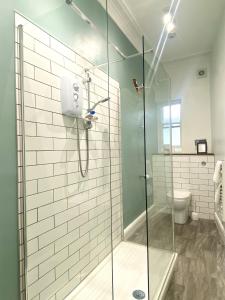 a bathroom with a glass shower with a toilet at St Paul's Road Townhouse by Clifton Short Lets in Bristol