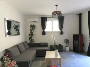 a living room with a couch and a window at Petit Cocon in Courthézon