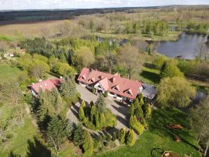 an aerial view of a house with trees and a river at Ranczo Brusno in Połczyn-Zdrój