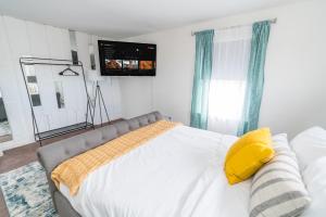 Schlafzimmer mit einem Bett und einem TV an der Wand in der Unterkunft Seaside in Guilford