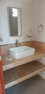 baño con bañera blanca grande y espejo en Altamar en Zihuatanejo