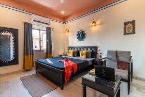 a bedroom with a bed and a laptop on a table at The Hosteller Jodhpur in Jodhpur