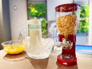 a red blender on a counter with a bowl of food at HOTEL SUI AKASAKA by ABEST in Tokyo