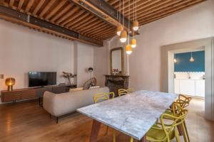 a living room with a table and a couch at Passage de l’Evêché in Annecy