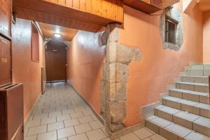 a hallway with stairs and a cross on the wall at Passage de l’Evêché in Annecy