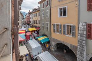 an overhead view of a street with vendors and umbrellas at Passage de l’Evêché in Annecy