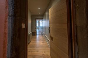 a hallway with wooden flooring and a hallway with a door at Passage de l’Evêché in Annecy +45 photos