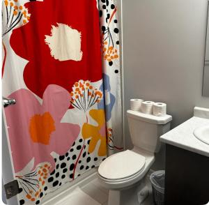 a bathroom with a toilet and a shower curtain at Cozy Whitby Retreat in Whitby