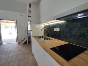 a kitchen with a sink and a counter top at 28 Casa do Avô - 2Km from the beach in Sesimbra