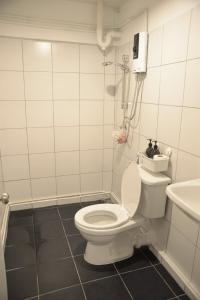 a bathroom with a toilet and a sink at BPP Resident near Donmueang Airport in Ban Don Muang