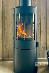 a blue oven with a fire in it at New cabin at Skeikampen, perfect for families! in Svingvoll +23 photos