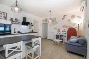 a kitchen and living room with a table and a couch at Apartment Vinotoč Izola in Izola