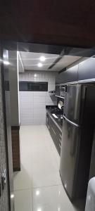 a small kitchen with a refrigerator and a stove at O melhor refúgio para o FIG 2024 in Garanhuns