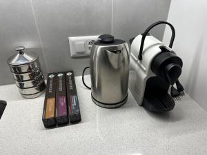 a counter top with a coffee maker and a blender at Grand Appartement Lumineux - STELLA Loft - À deux pas du Lac Léman in Veytaux