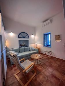 a living room with a couch and a table at 'La Casa della Sirena 2' in Plaka Milou
