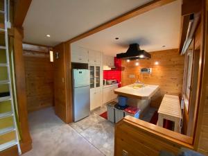 a small kitchen with a sink and a refrigerator at Annupuri Retro Lodge in Niseko