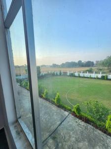 a view of a soccer field from a window at Shanti Niwas in Varanasi