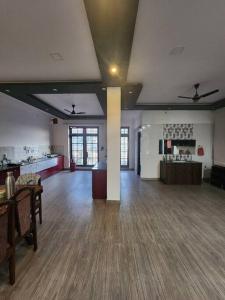 an empty room with a large room with wood floors and ceilings at Shanti Niwas in Varanasi