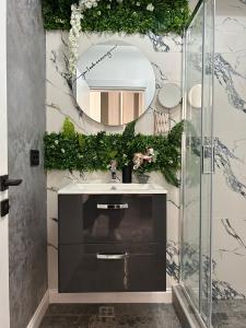 a bathroom with a sink and a mirror at Sara Boutique Villa in Constanţa