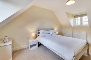 a bedroom with a large white bed and a window at Pass the Keys Cute cottage in Pembury with parking in Pembury