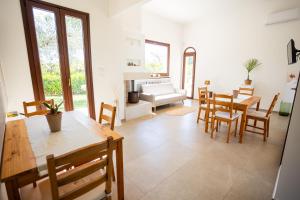 a living room with a table and chairs and a couch at Villa Mamma Grazia Rooms in San Vito dei Normanni