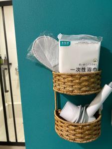 a pair of baskets with toothbrushes in them at 7 guest house in Hong Kong