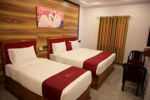 Ένα ή περισσότερα κρεβάτια σε δωμάτιο στο Ramraj Resort