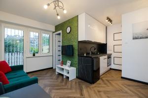 a kitchen and living room with a couch and a table at U Księcia Józefa in Pruszków