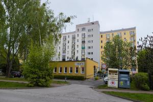a street with a yellow building and a white building at U Księcia Józefa in Pruszków