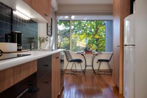 a kitchen with a table and chairs and a window at Daylesford Spa Villa 5 in Daylesford