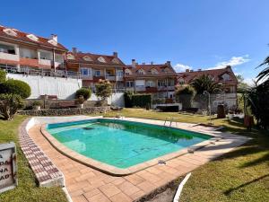 a swimming pool in the yard of a house at Apartamento La Caleta III - Monabri in Mogro