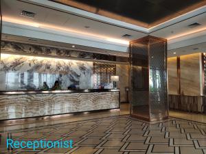 a lobby of a hotel with a reception counter at Comodo Apartemen Pollux Habibie Rooftop-SeaView in Batam Center