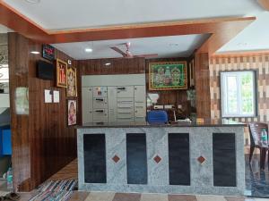 a bar in a room with wooden walls at SDD Grand in Tiruvannāmalai