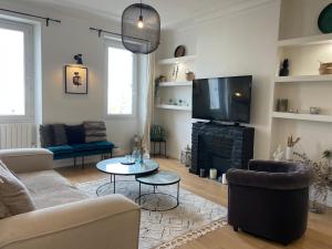 a living room with a couch and a tv at Grande chambre cosy in Marseille