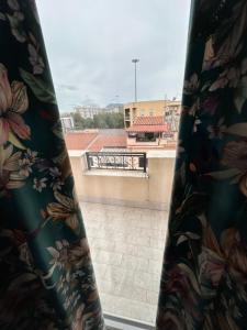a curtain on a window with a view of a building at Dimora del Buongustaio in Palermo