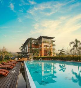 a resort with a swimming pool and a building at Sueen Nature Resort in Hatton