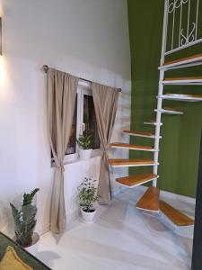 a spiral staircase in a room with potted plants at Gallery apartment in Podgorica