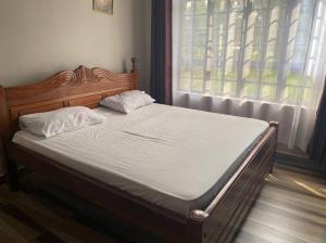 a bed in a bedroom with a large window at Homa Bay Four bedroom Villa in Kabondo +8 photos